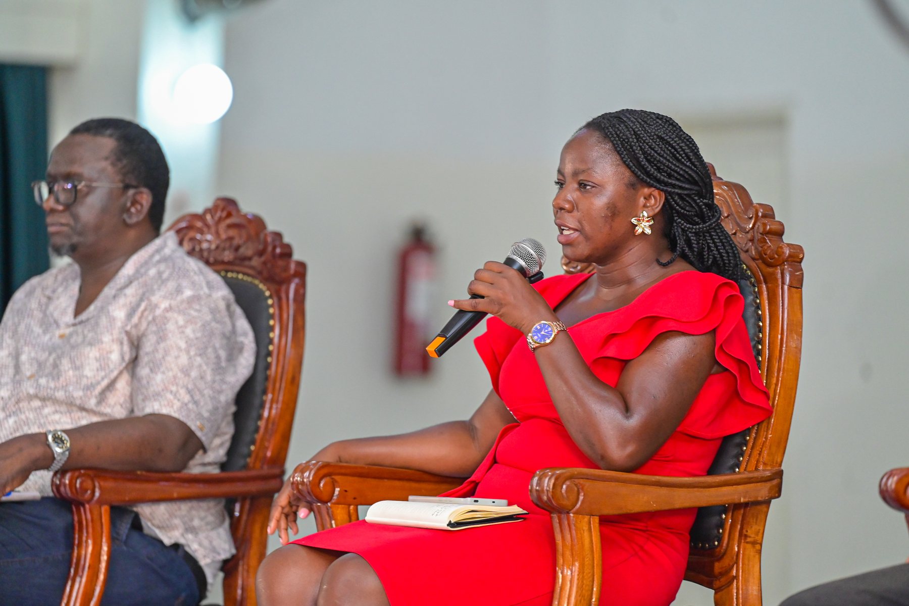 A woman in red making a contribution from the panel