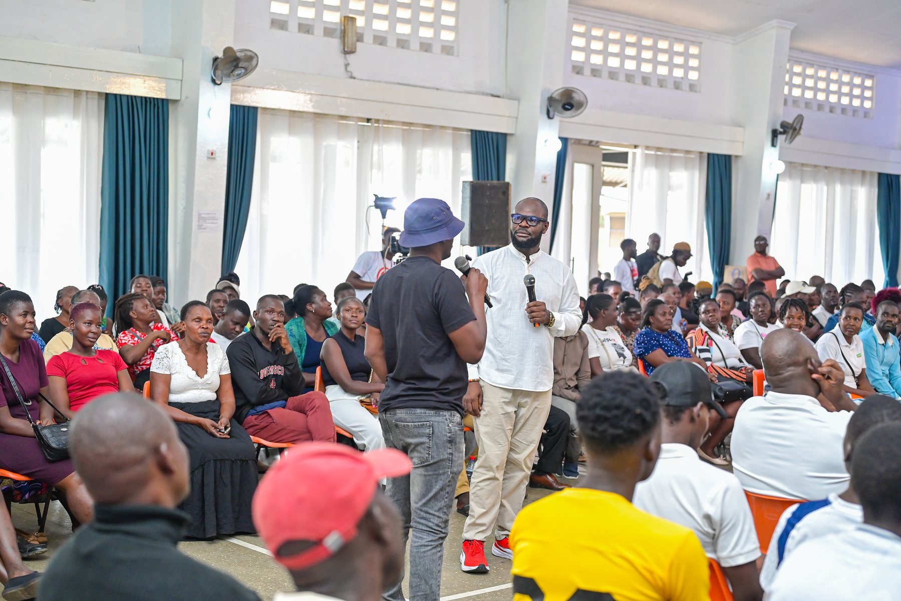 The moderator listening to a participant speaking from the audience