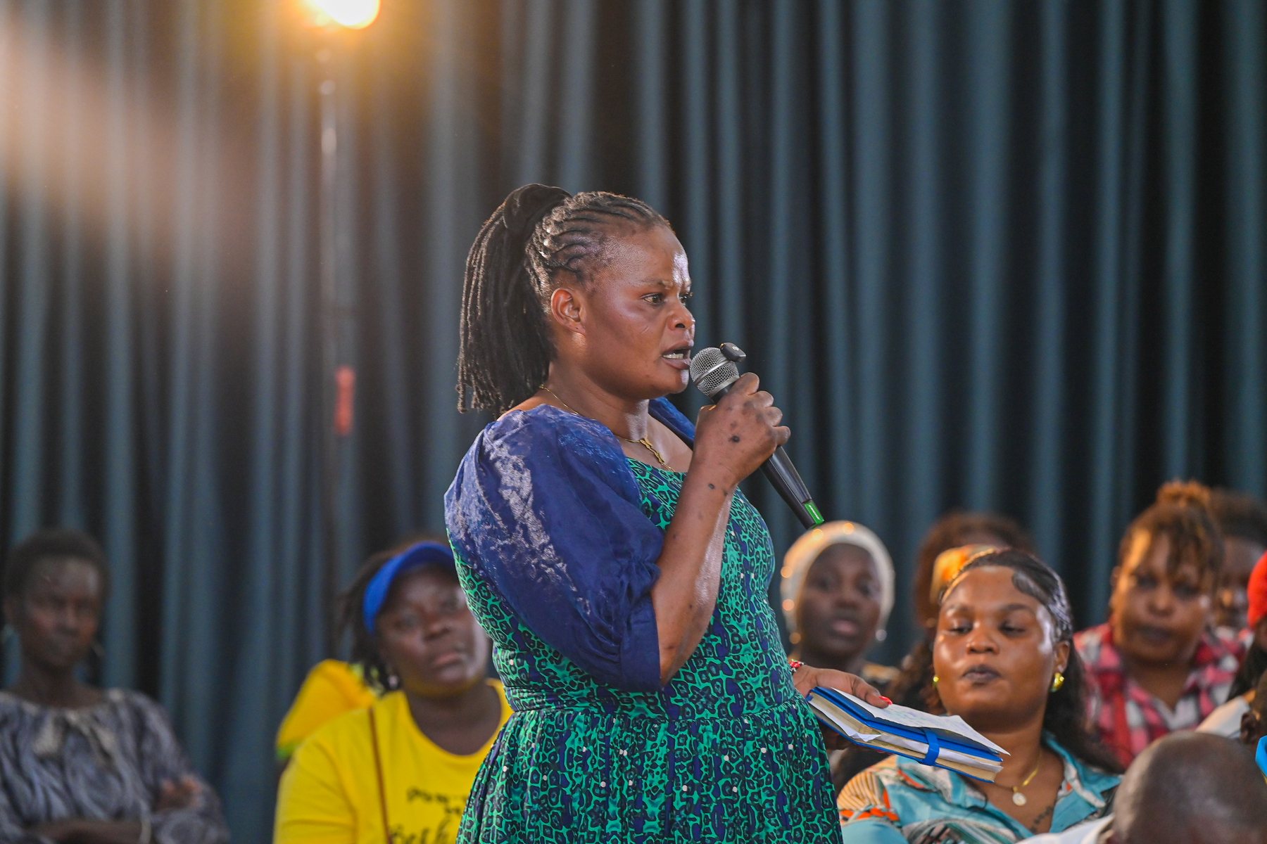 A woman contributing to the forum from the audience