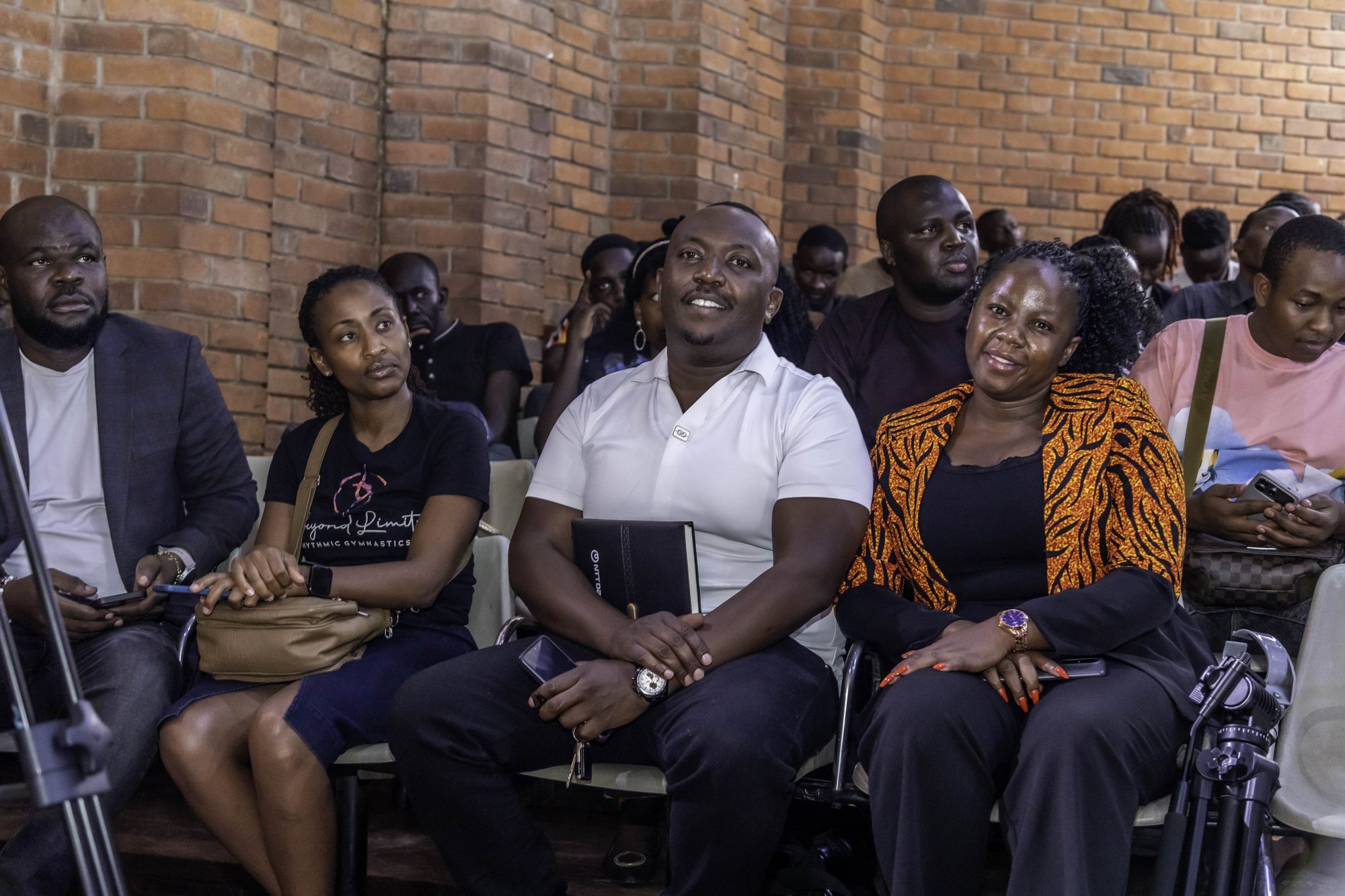 Audience members listening in the front row