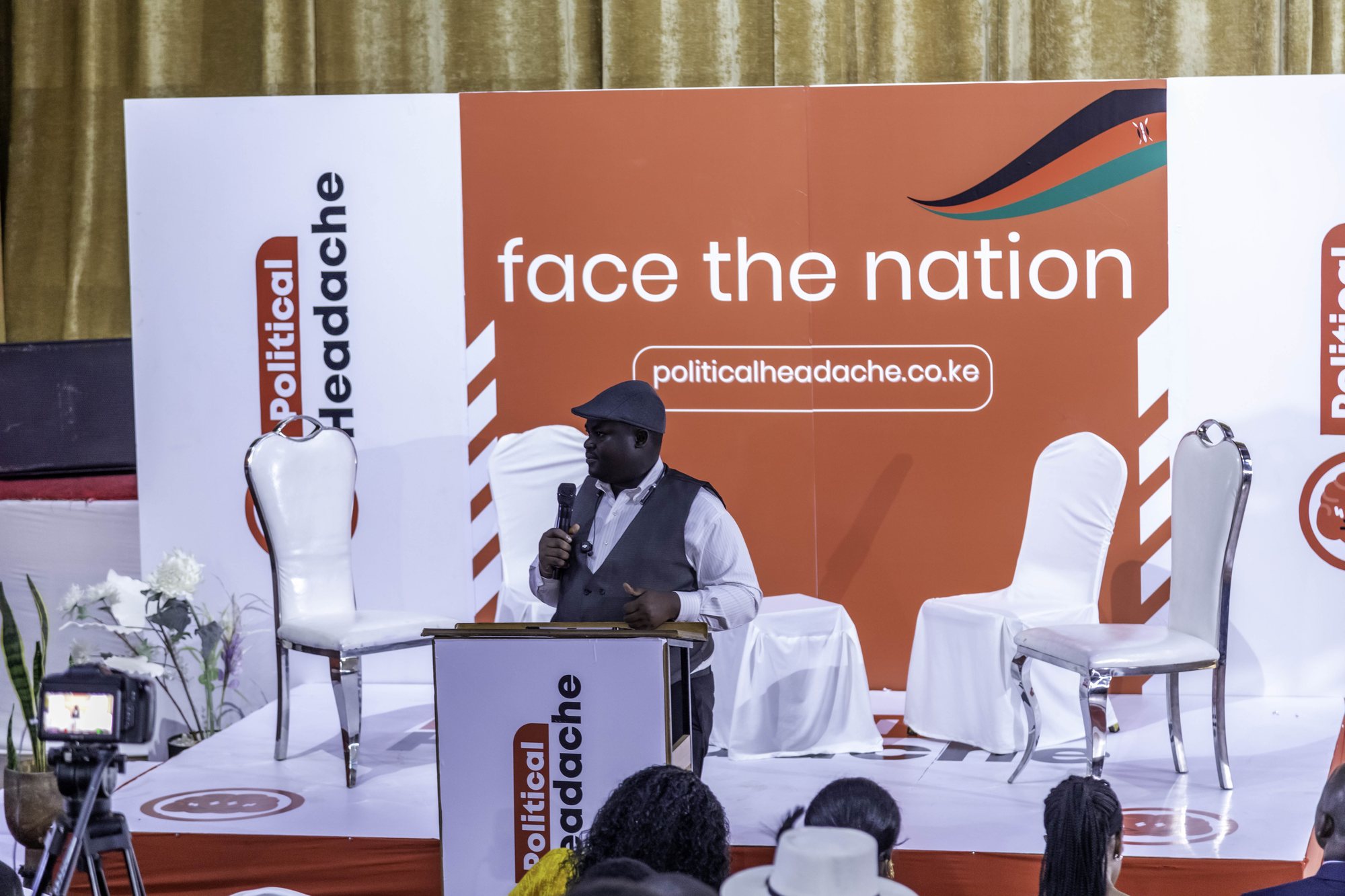 A speaker at the lectern before the Face The Nation stage
