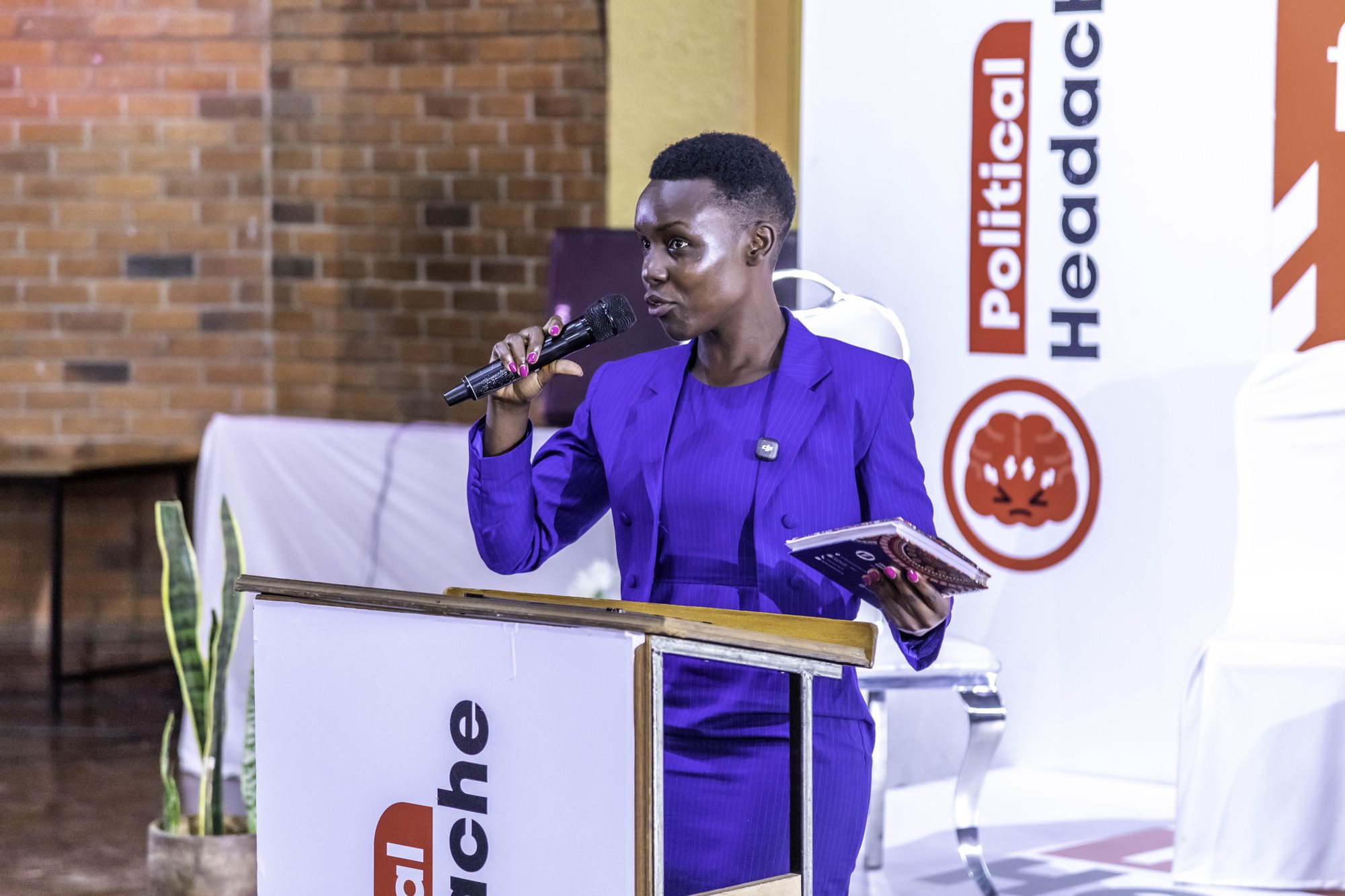 A woman in purple addressing the forum from the lectern